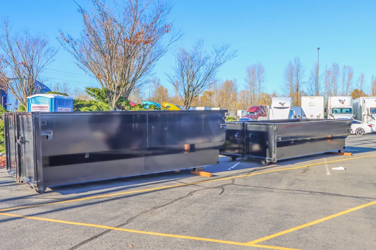 Professional dumpster rental service with roll-off container on residential driveway in Mendota